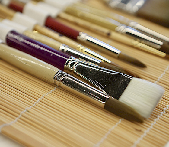 Close up photo of paintbrushes in an open brush case.